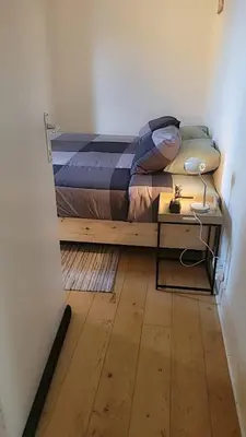 a bedroom with a bed and a desk with a lamp at Brussels Royal - Freedom Square in Brussels