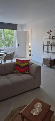a living room with a couch and a table at Cosy flat in Antwerp