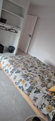 a bed in a room with a blanket on it at Cosy flat in Antwerp