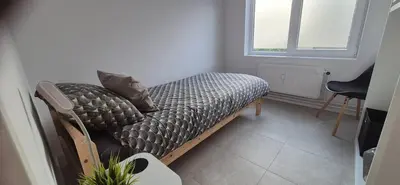 a bed with pillows on it in a room at Cosy flat in Antwerp
