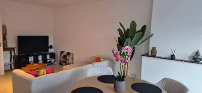 a living room with a couch and a table at Cosy flat in Antwerp