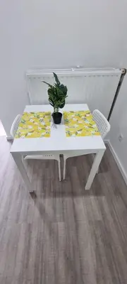 a white table with a potted plant on it at CitySpot 159 in Brussels