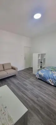 a living room with a couch and a bed at CitySpot 159 in Brussels