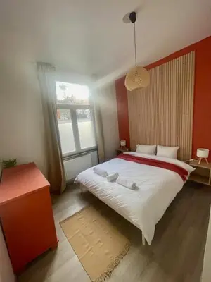 a bedroom with a large bed and a window at Le longue vie in Brussels