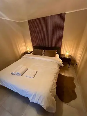 a bedroom with a white bed with two towels on it at Le longue vie in Brussels