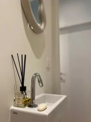 a sink in a bathroom with a mirror at Designer Apartment on the Skyline of Brussels in Brussels