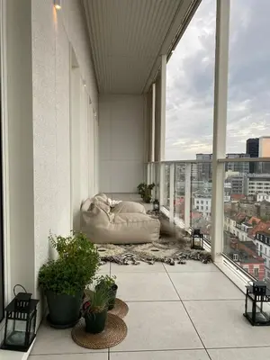 a living room with a couch on the floor of a building at Designer Apartment on the Skyline of Brussels in Brussels