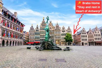 a statue in the middle of a city with buildings at Grote Markt suite 3 in Antwerp