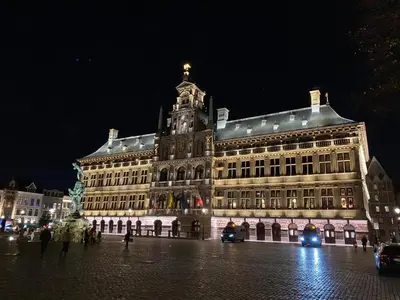 a large building with a statue in front of it at night at Grote Markt suite 3 in Antwerp