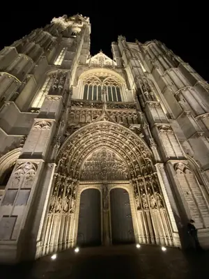 a tall building with a lit up facade at night at Grote Markt suite 3 in Antwerp