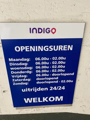 a sign hanging on a wall with a sign for an entrance at Grote Markt suite 3 in Antwerp