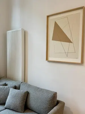 a living room with a couch and a picture on the wall at Urban Nest - Brussels in Brussels