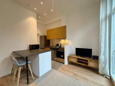 a kitchen with a table and a counter top at The Modern Nest - Jourdan in Brussels