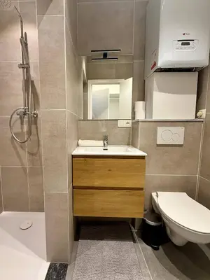a bathroom with a sink and a toilet and a shower at The Modern Nest - Jourdan in Brussels