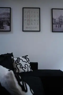a living room with a couch and pictures on the wall at Diesters huisje in Diest