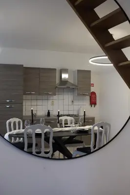 a dining room with a table and chairs in a mirror at Diesters huisje in Diest