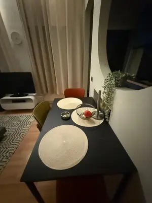 a table with two white plates on top of it at Antwerpen duplex apartment in Antwerp