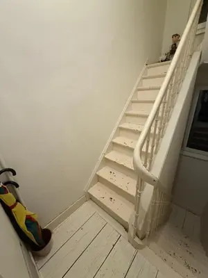a white staircase in a room with a wooden floor at Antwerpen duplex apartment in Antwerp