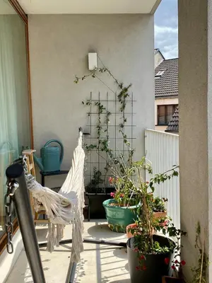 a patio with potted plants on a balcony at Spacious & cosy apartment center in Ghent