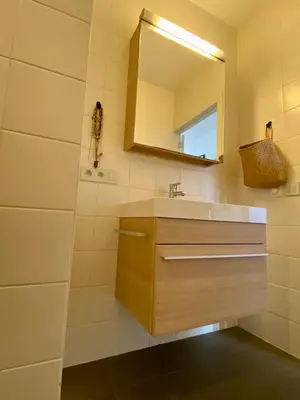 a bathroom with a sink and a mirror at Spacious & cosy apartment center in Ghent