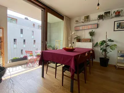 a dining room with a table with a purple table cloth at Spacious & cosy apartment center in Ghent