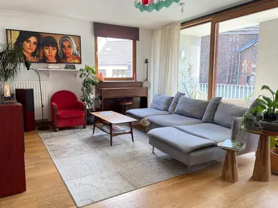a living room with a couch and a piano at Spacious & cosy apartment center in Ghent