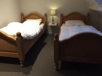 two beds sitting next to each other in a room at Vakantie Appartement De Sneppelhoeve in Wuustwezel