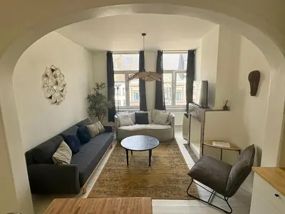 a living room with a couch and a table at T' Suikerklontje in Antwerp