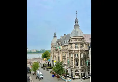 a large building with a tower on top of it at T' Suikerklontje in Antwerp