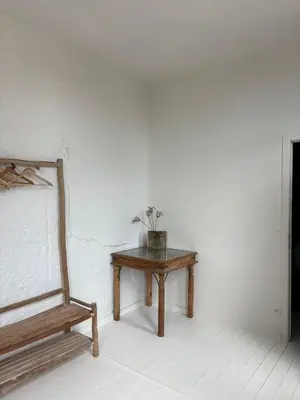 a wooden bench sitting in a room with a table at T' Suikerklontje in Antwerp