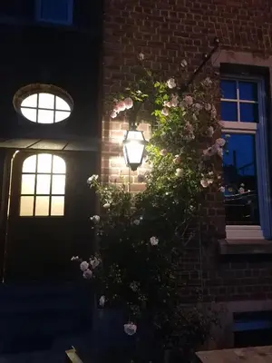 a house with a flowering plant on the side of it at Meerdael Refuge Appartement in Oud-Heverlee