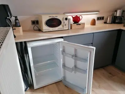 a white refrigerator in a kitchen with a microwave at Meerdael Refuge Appartement in Oud-Heverlee