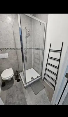 a bathroom with a shower and a toilet at Studio cozy et charmant in Brussels