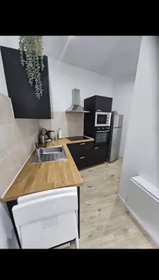 a kitchen with a sink and a counter top at Studio cozy et charmant in Brussels