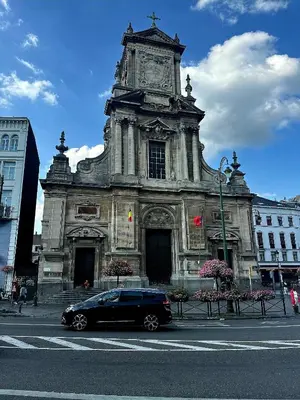 a car parked in front of a building with a clock tower at Studio cozy et charmant in Brussels
