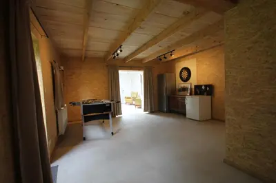 a kitchen with a refrigerator and a table in a room at Huisje Nostalgie in Laakdal
