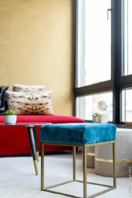 a blue bench in a living room with a couch at Ecstatic Living Ixelles, Luxury in the European Quarter in Brussels