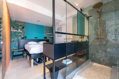 a bathroom with a shower and a bedroom at Ecstatic Living Ixelles, Luxury in the European Quarter in Brussels