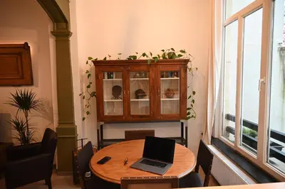 a laptop sitting on a wooden table in a room at P60 Character & Comfort in 1000 Brussels in Brussels