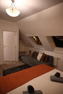 a living room with a bed and a couch at Vintage Soul, Green Vibes, Heart of the City in Brussels