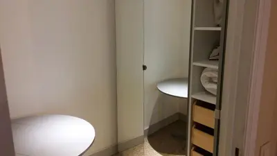 a room with a closet with a stool and a mirror at Central and convenient studio near supermarkets and public transports in Brussels