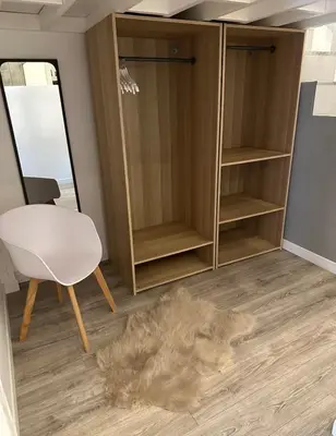 a room with a white chair and a mirror at Antwerp West Side ,airco in Zwijndrecht