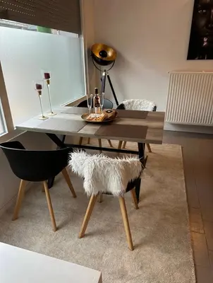 a dining room table and chair with a wooden table at Antwerp West Side ,airco in Zwijndrecht