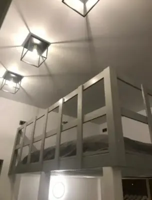 a room with two lights on the ceiling and a bed at Antwerp West Side ,airco in Zwijndrecht