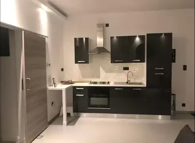 a kitchen with a sink and a stove at Antwerp West Side ,airco in Zwijndrecht