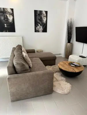 a living room with a couch and a coffee table at Antwerp West Side ,airco in Zwijndrecht