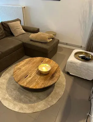 a living room with a wooden table and a couch at Antwerp West Side ,airco in Zwijndrecht