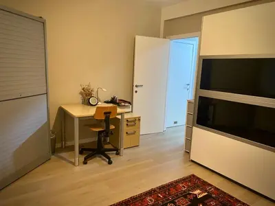 a room with a desk and a tv and a desk with a desk at Modern 2-Bed Urban Apartment in Brussels