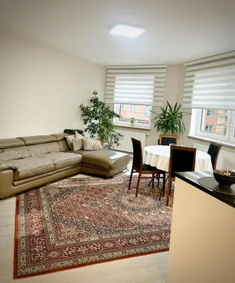 a living room with a couch and a table at Modern 2-Bed Urban Apartment in Brussels