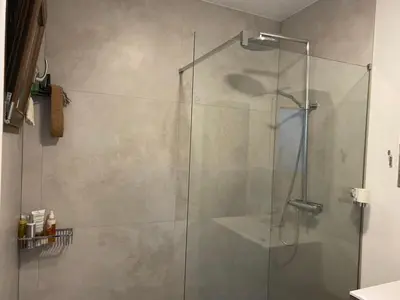 a shower with a glass door in a bathroom at Modern 2-Bed Urban Apartment in Brussels